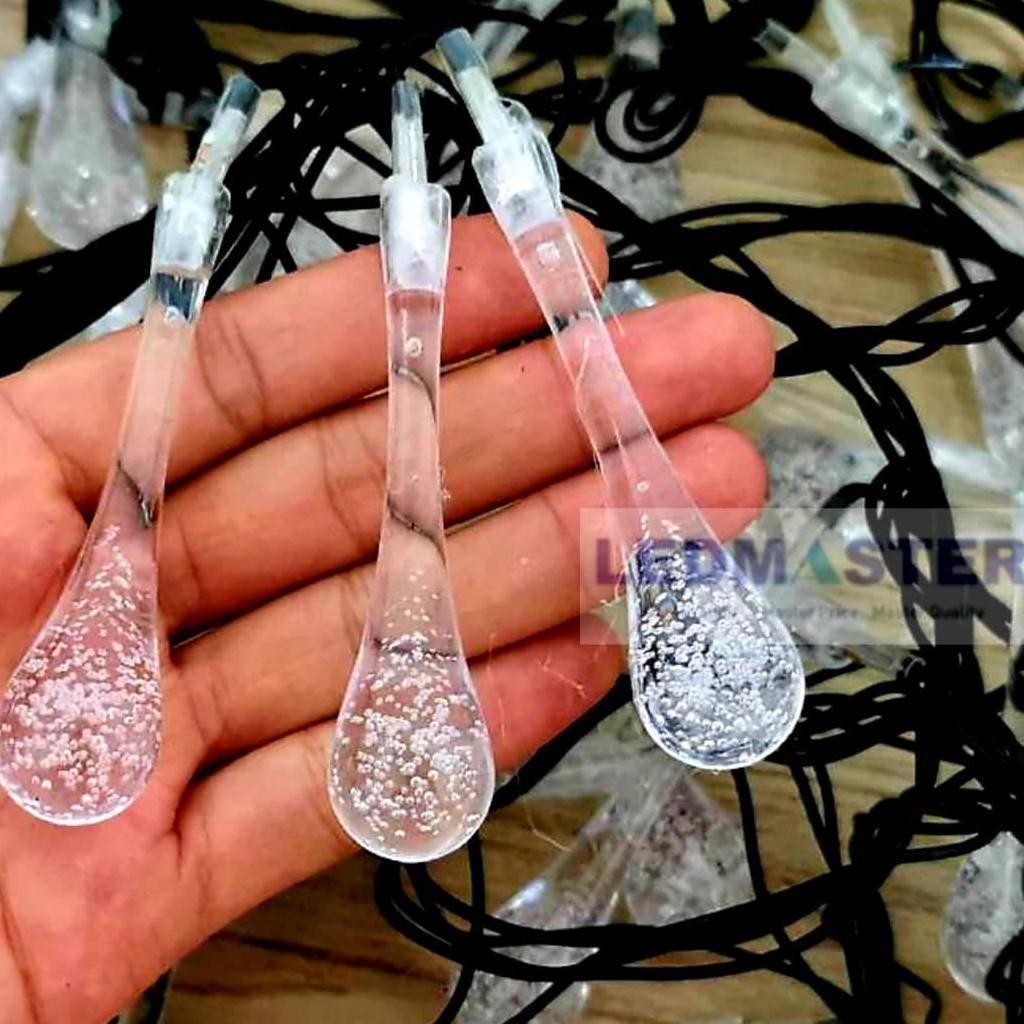 ไฟคริสมาส ไฟปีใหม่ ไฟประดับตกเเต่ง ทรงใสหยดน้ำขนาดใหญ่ จำนวน 70 LED ความยาว 9 เมตร ( หลอดยาว 9 CM ) สายสีดำ งานดี ทนทาน เเสงสีรวม RGB เเบบไฟกระพริบ ใช้สำหรับเป็นไฟเเฟนซีประดับอาคาร ไฟประดับต้นไม้ ไฟประดับต้นคริสมาส ไฟประดับปีใหม่ ไฟงานวัด ไฟเส้นตกเเต่ง