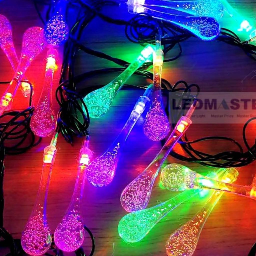 ไฟคริสมาส ไฟปีใหม่ ไฟประดับตกเเต่ง ทรงใสหยดน้ำขนาดใหญ่ จำนวน 70 LED ความยาว 9 เมตร ( หลอดยาว 9 CM ) สายสีดำ งานดี ทนทาน เเสงสีรวม RGB เเบบไฟกระพริบ ใช้สำหรับเป็นไฟเเฟนซีประดับอาคาร ไฟประดับต้นไม้ ไฟประดับต้นคริสมาส ไฟประดับปีใหม่ ไฟงานวัด ไฟเส้นตกเเต่ง